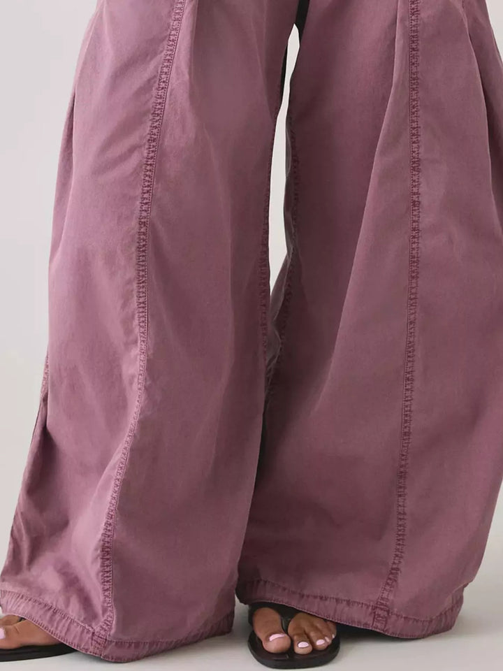 Close-up of mauve parachute cargo pants wide legs and hem