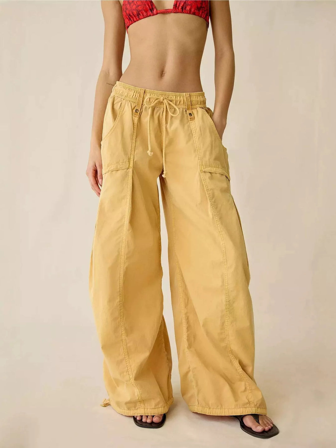 Mustard wide leg cargo pants with drawstring waist, front view with slides