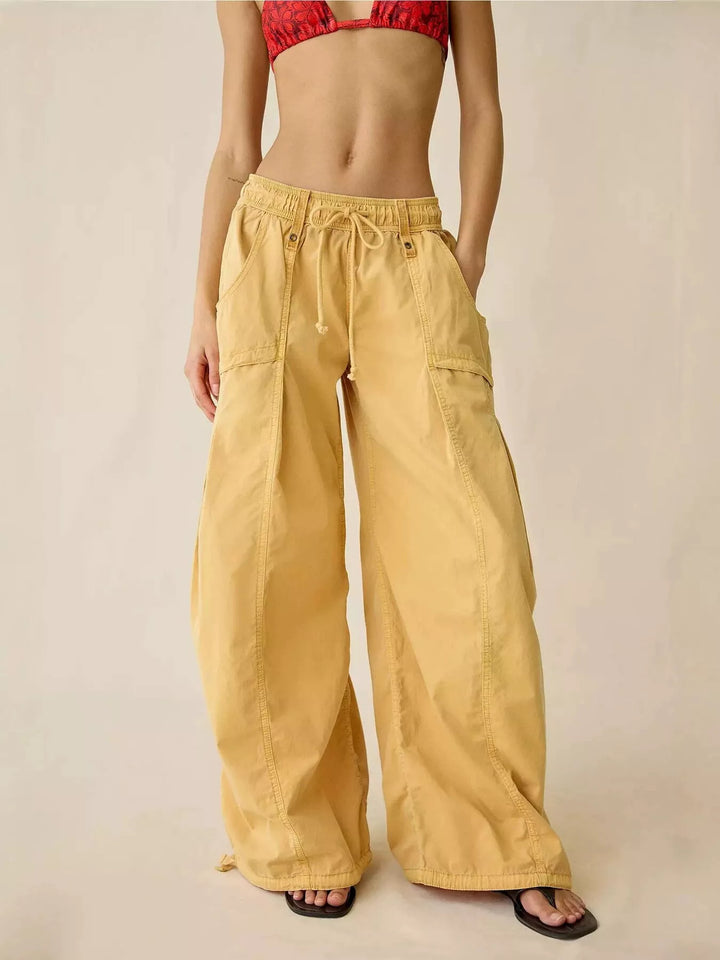 Mustard wide leg cargo pants with drawstring waist, front view with slides