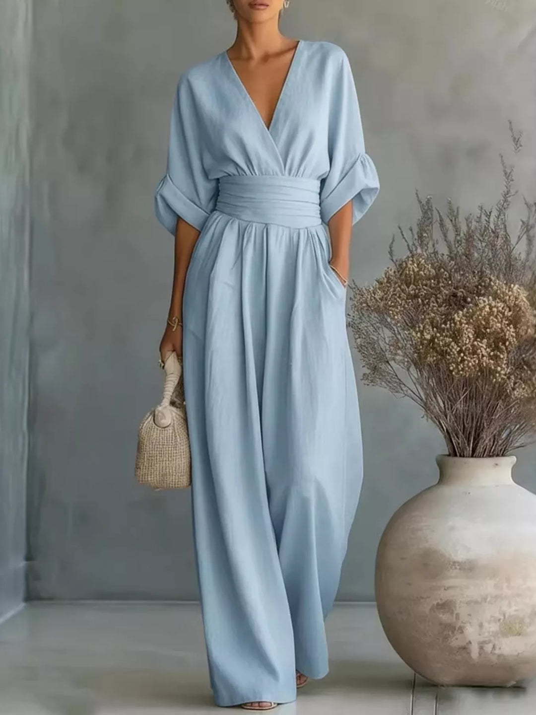 Women's casual jumpsuit in light blue, deep V neck wrap with half sleeves, front view