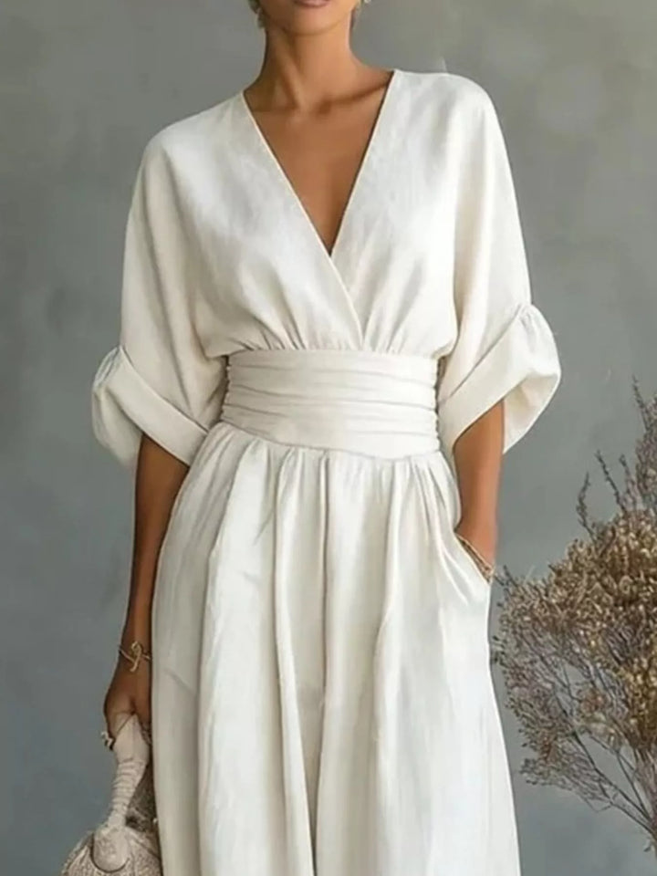 Close-up of the white wrap jumpsuit with a gathered waist and pocket