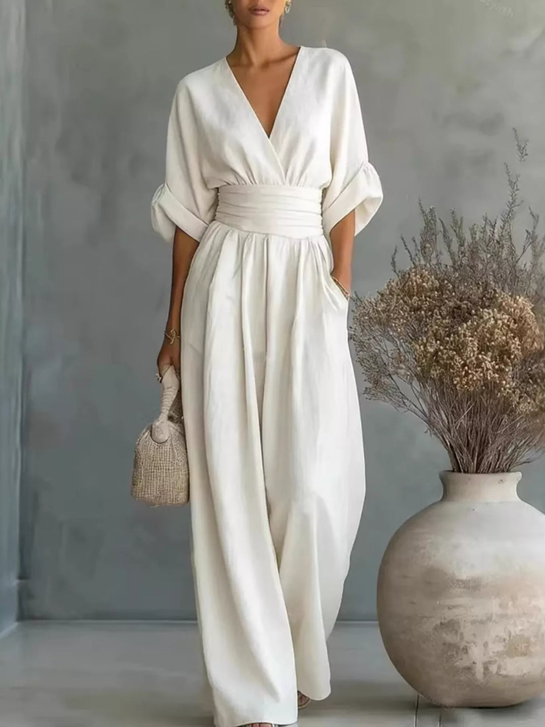 White casual jumpsuit with a wrap V neck and wide legs, front view