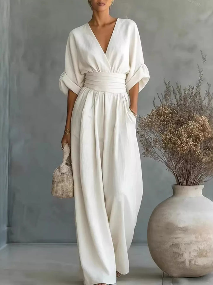 White casual jumpsuit with a wrap V neck and wide legs, front view