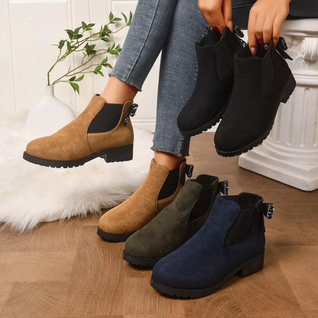Women's Chelsea boots in tan, olive, black and navy with pearl bow at the back