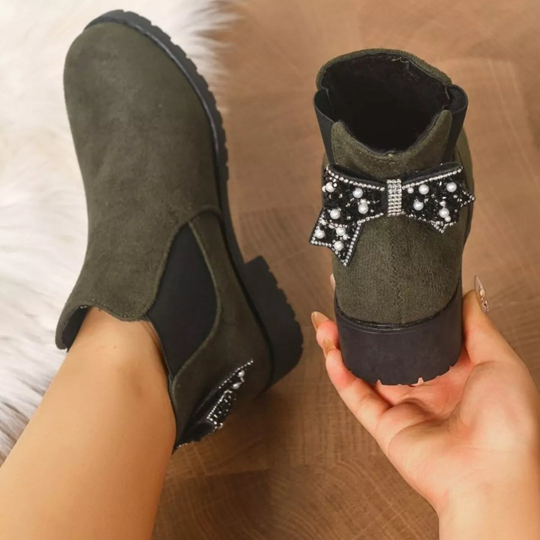 Back view of olive Chelsea boots showing the pearl and crystal bow