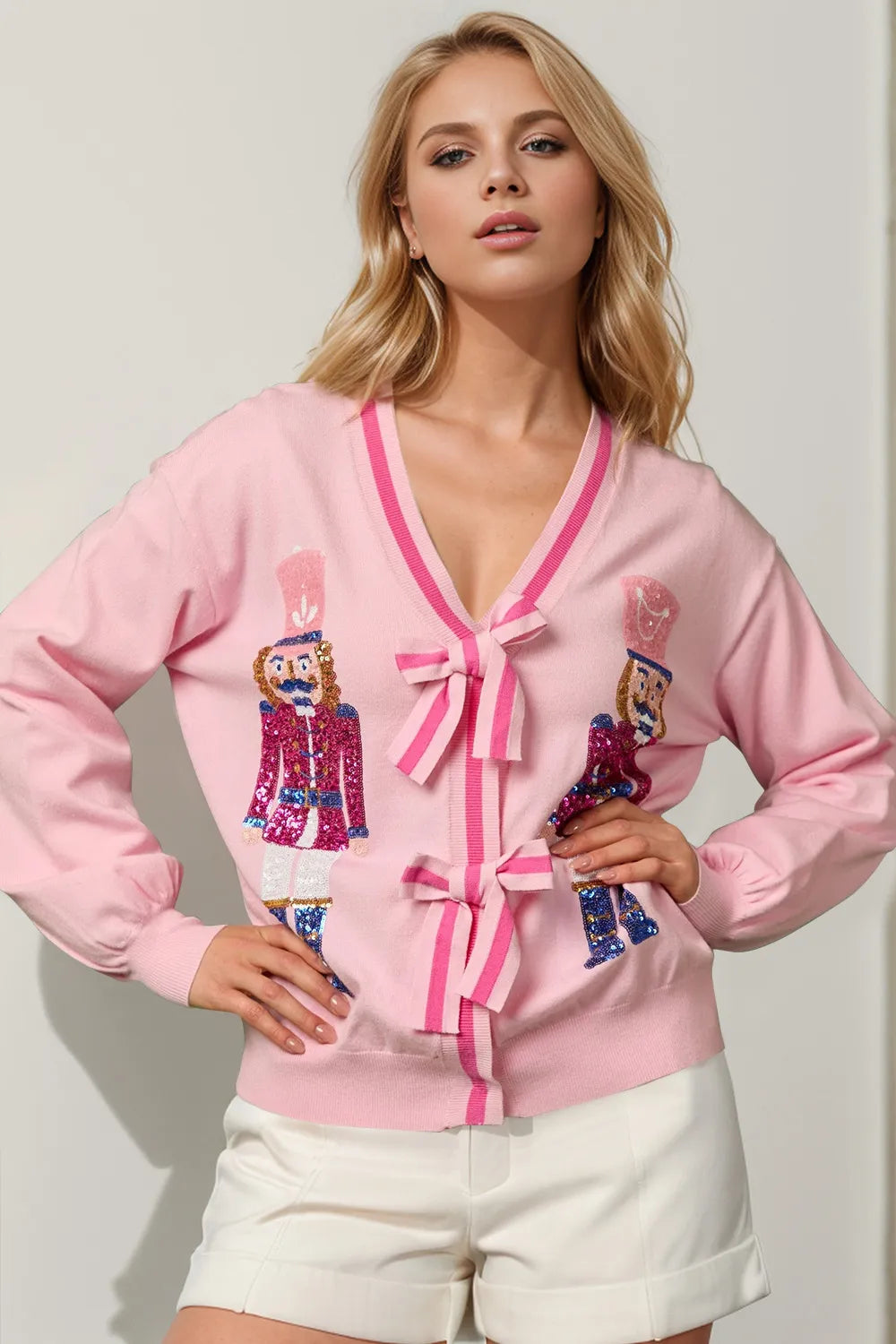 Blush pink sequin nutcracker cardigan with V neck and pink bows