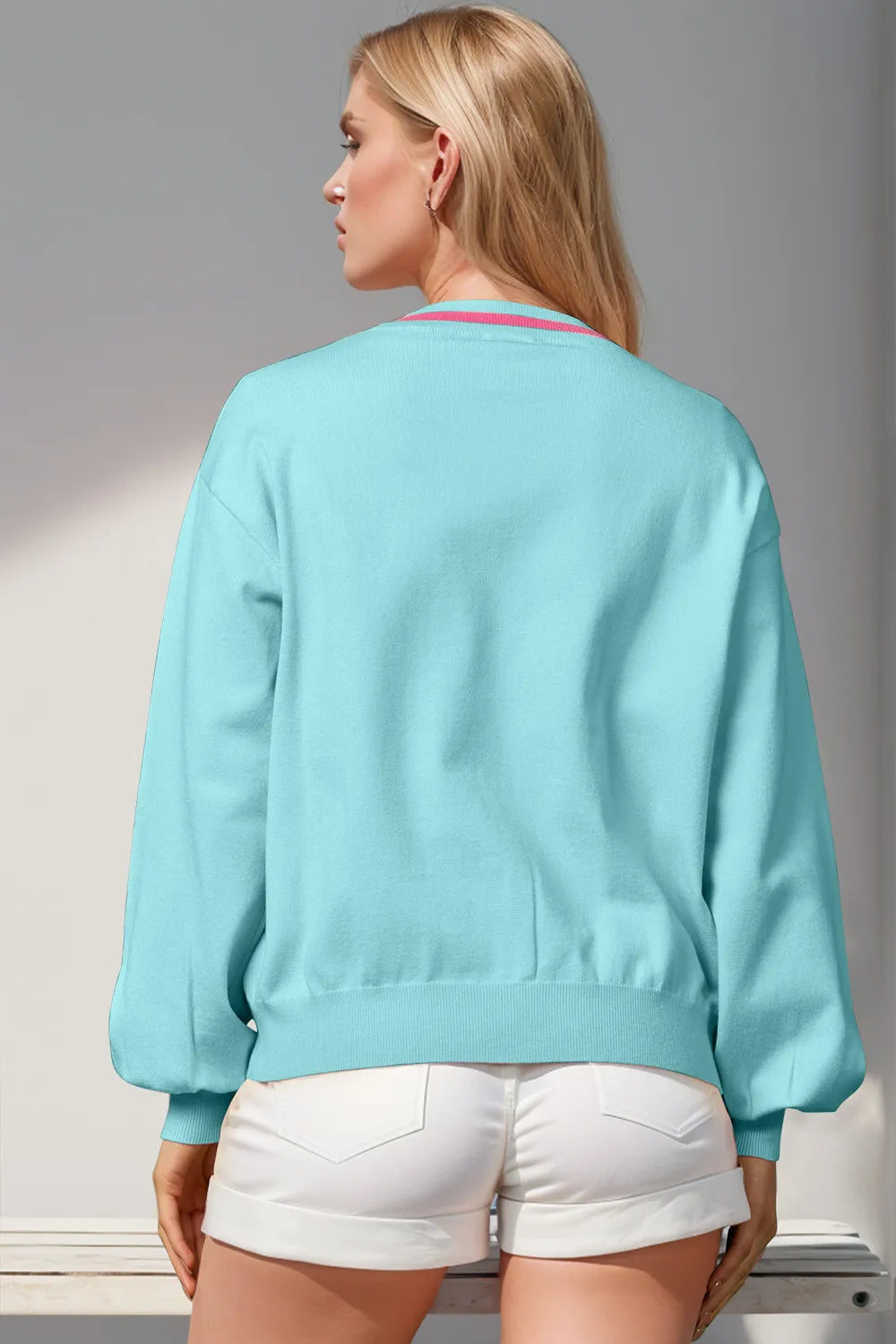 Back view of the light blue V neck cardigan with ribbed hem