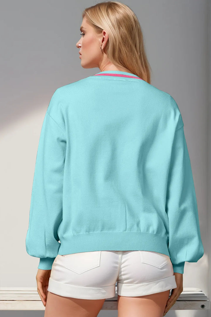 Back view of the light blue V neck cardigan with ribbed hem