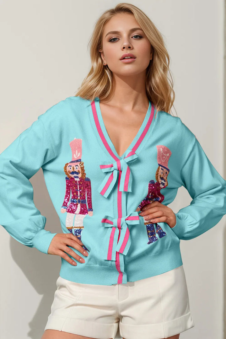 Women's Christmas cardigan in light blue, sequin nutcracker V neck with bow ties, over white shorts