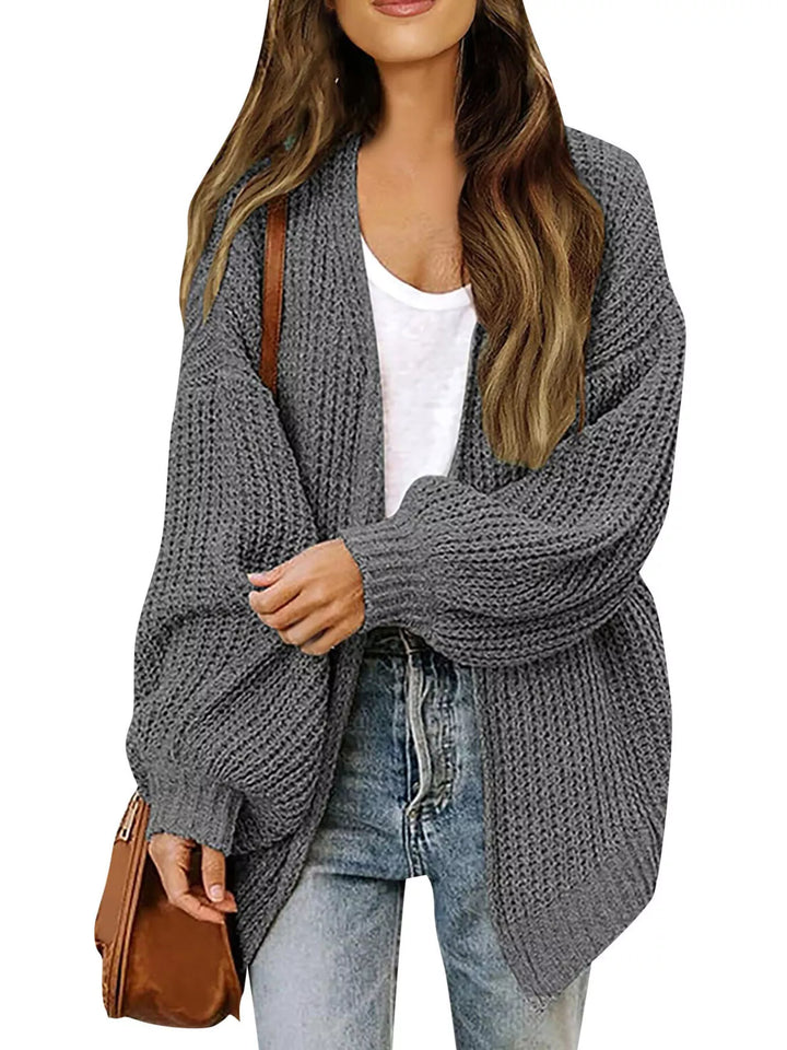 Charcoal oversized knit cardigan worn open with a brown shoulder bag