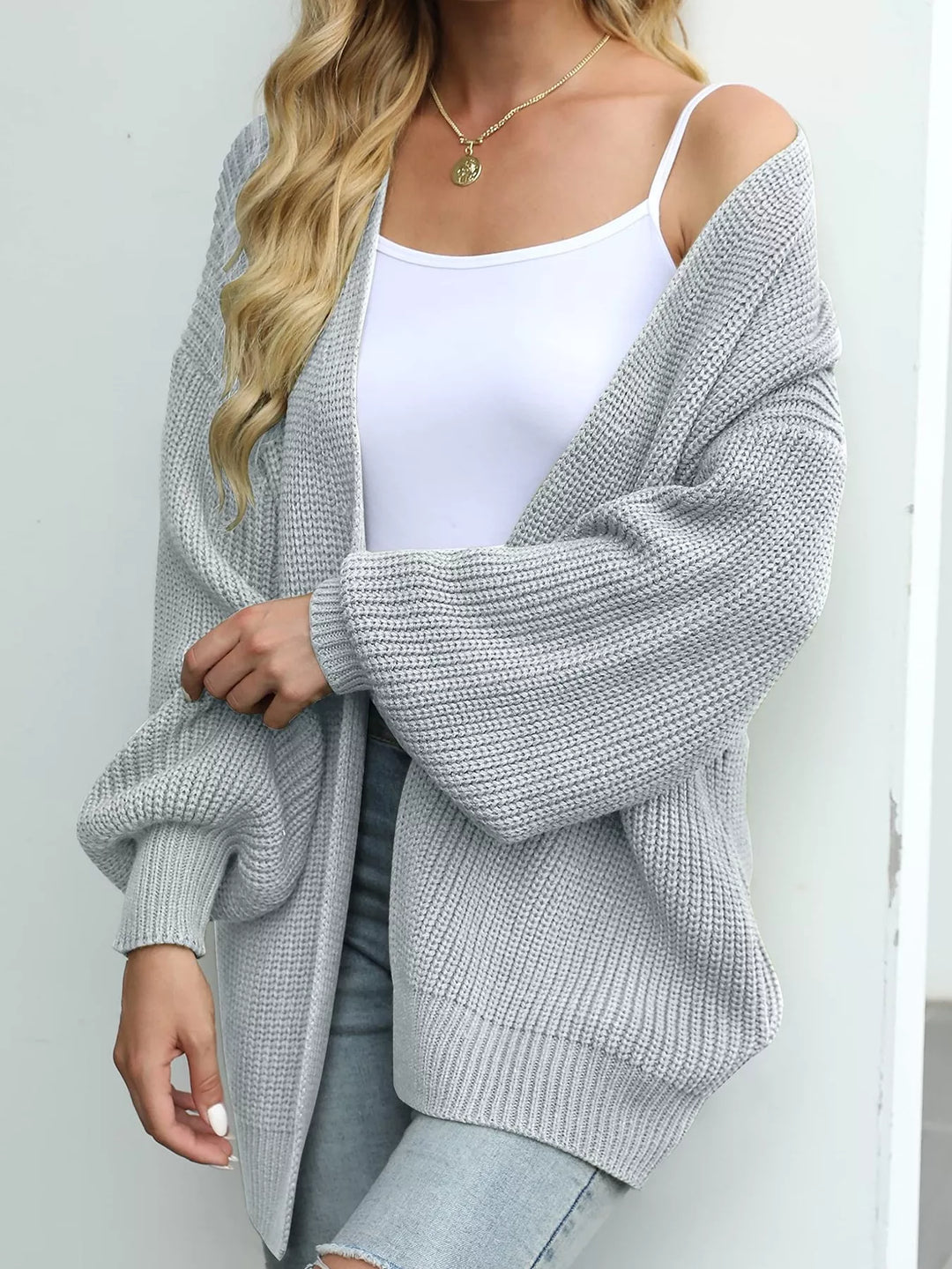 Light gray oversized batwing cardigan in a side view with a loose sleeve