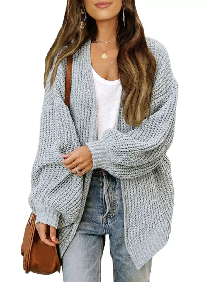 Light gray open front cardigan styled with a brown shoulder bag