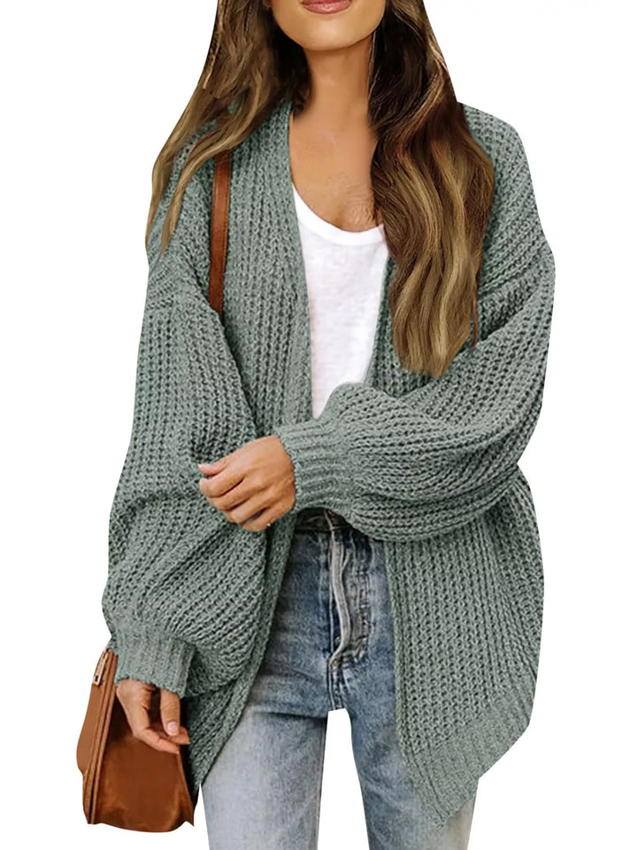 Sage open front chunky cardigan with batwing sleeves and light jeans