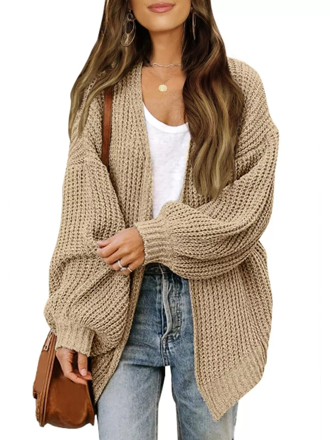 Tan open front batwing cardigan styled with jeans and a brown bag