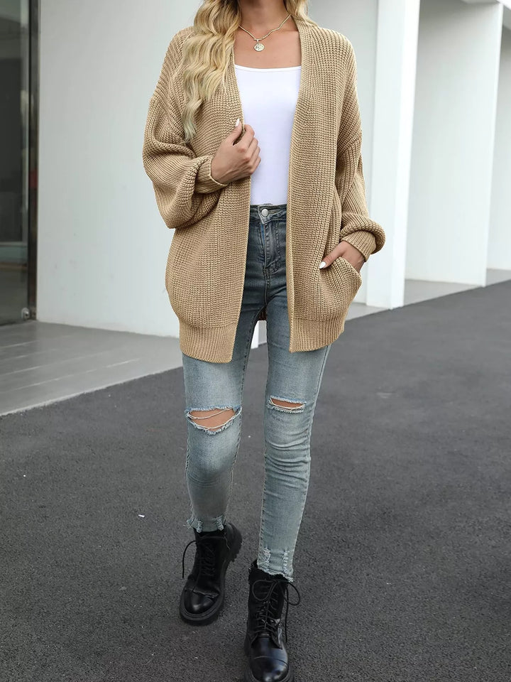 Full-length camel cardigan styled with ripped jeans and black boots
