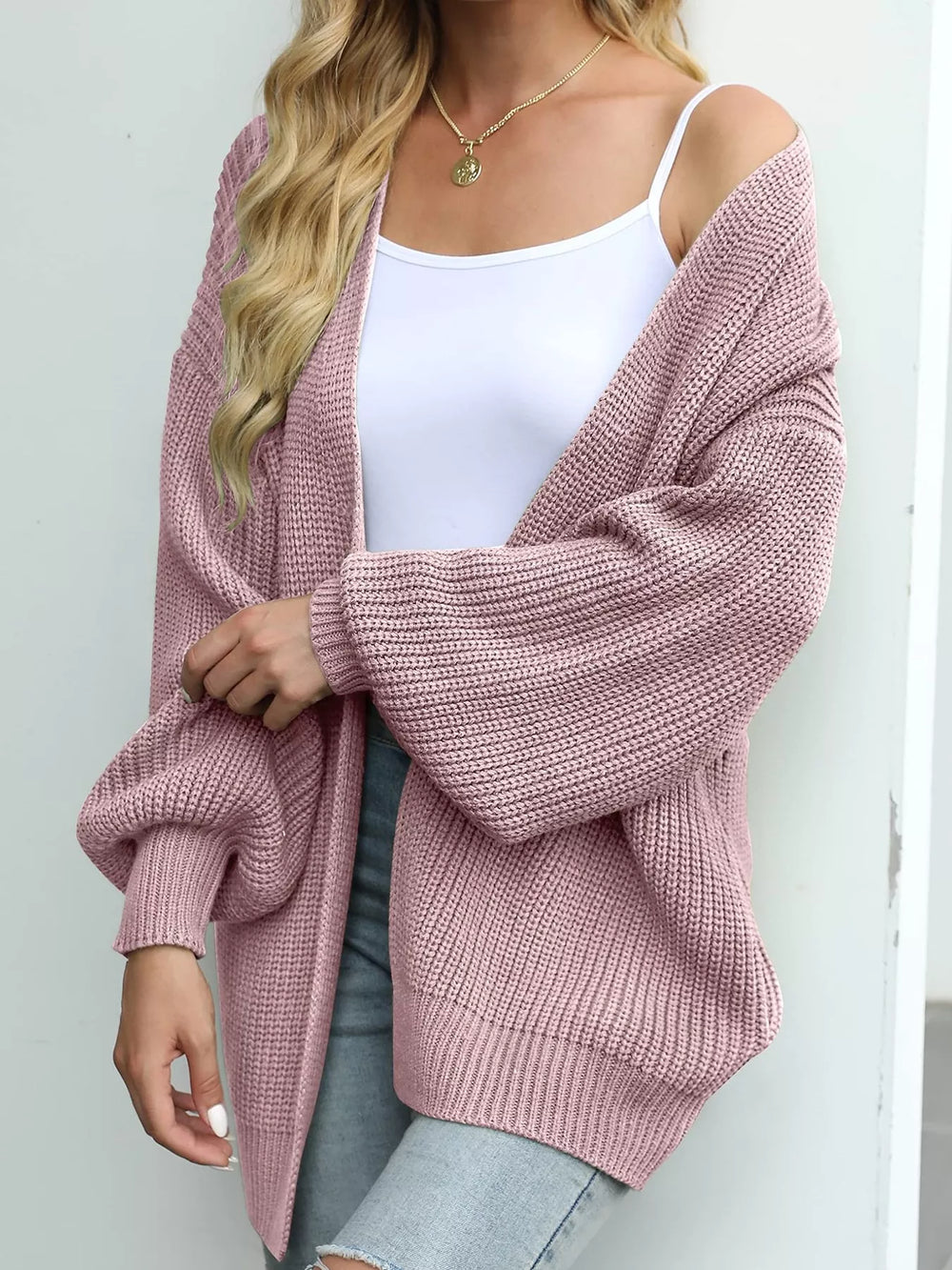 Dusty pink open front cardigan with lantern sleeves, angled view over a white tank