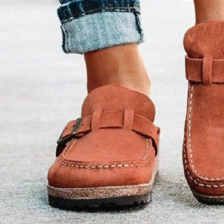Rust wedge clog toe detail and cork style sole, worn on pavement