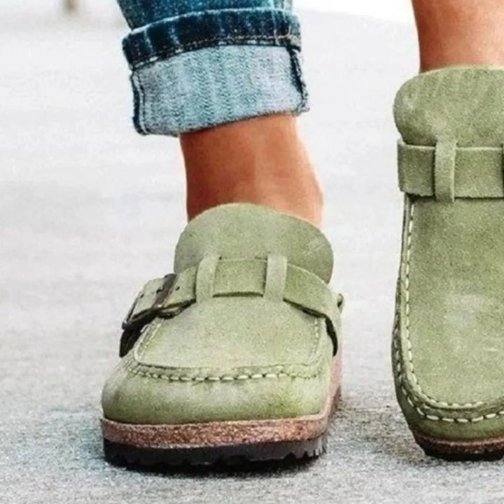 Sage clog front detail with stitched toe and strap, other shoe behind