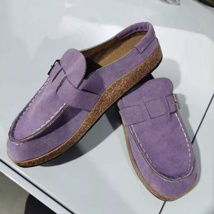 Pair of lilac clogs with buckle strap and cork-look footbed, top angle