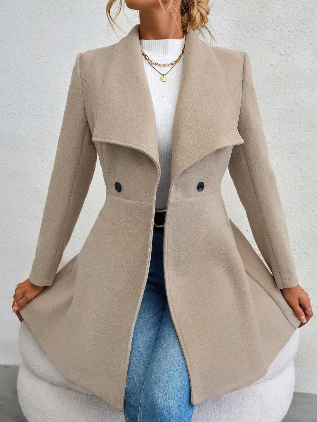 Beige fit and flare coat with flared skirt, full length standing