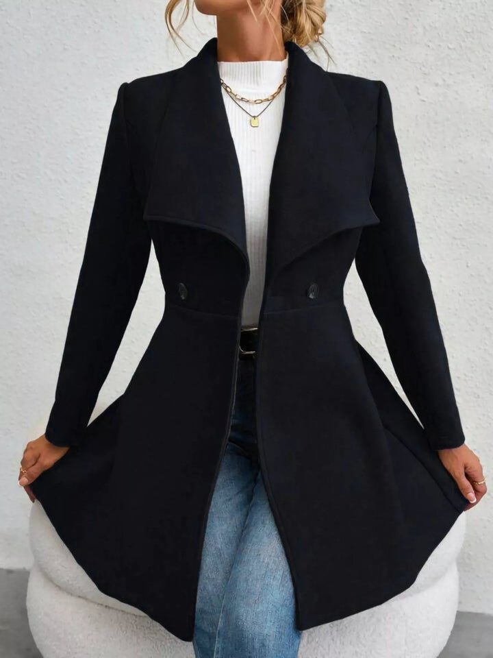 Black flared coat held at the skirt, full length view