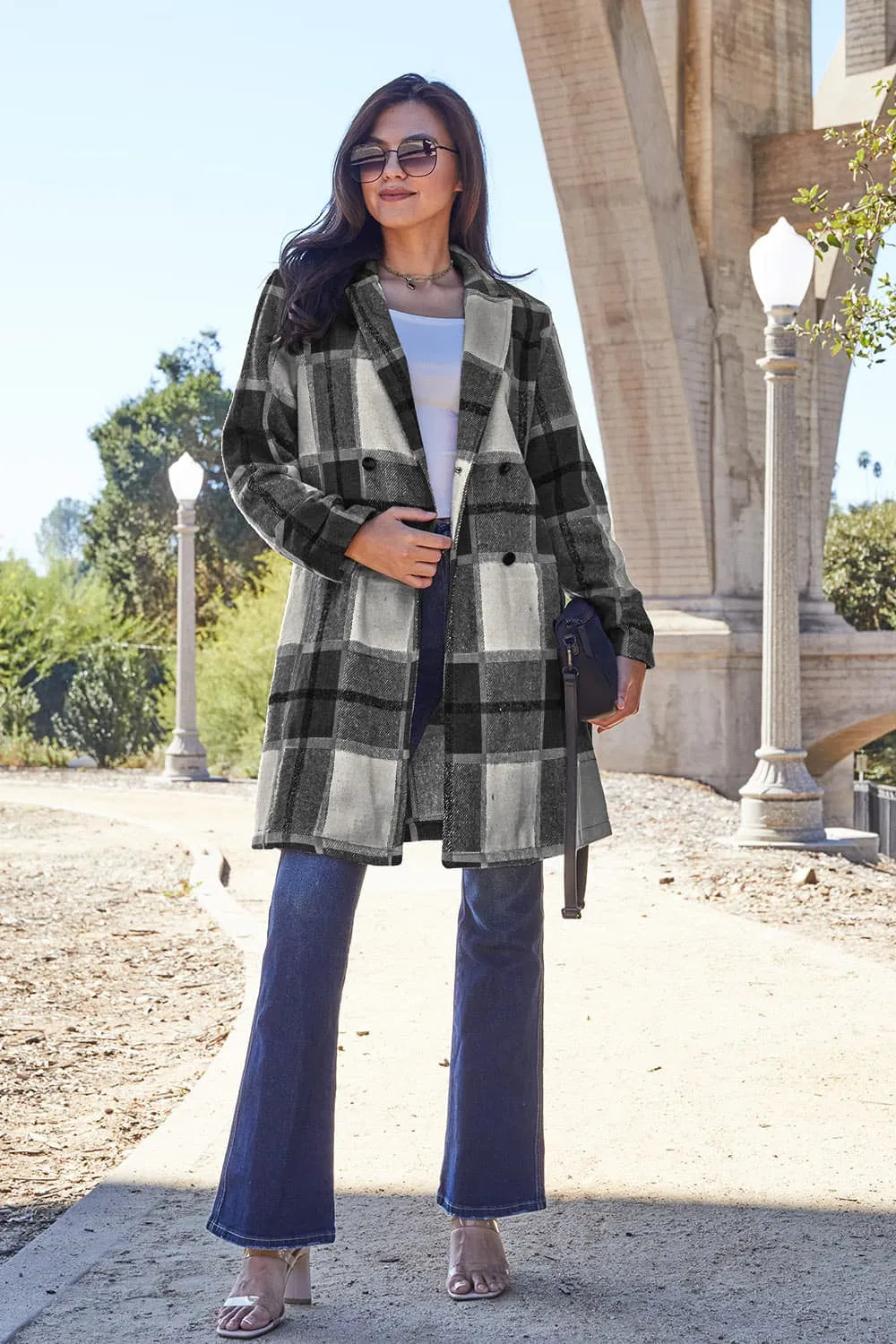 Black plaid coat mid length styled with flare jeans and a shoulder bag