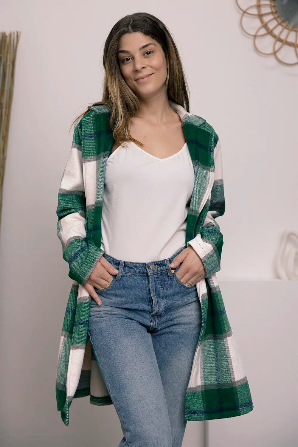 Green plaid coat worn open with a smile, styled with blue jeans
