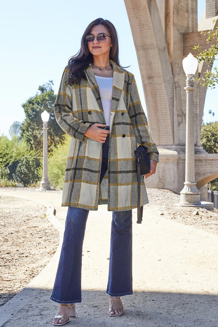 Olive plaid coat mid length with notch lapel, worn with flare jeans and a bag