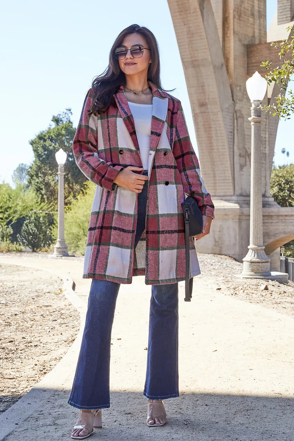 Red plaid coat mid length with notch lapel, worn with flare jeans and a bag