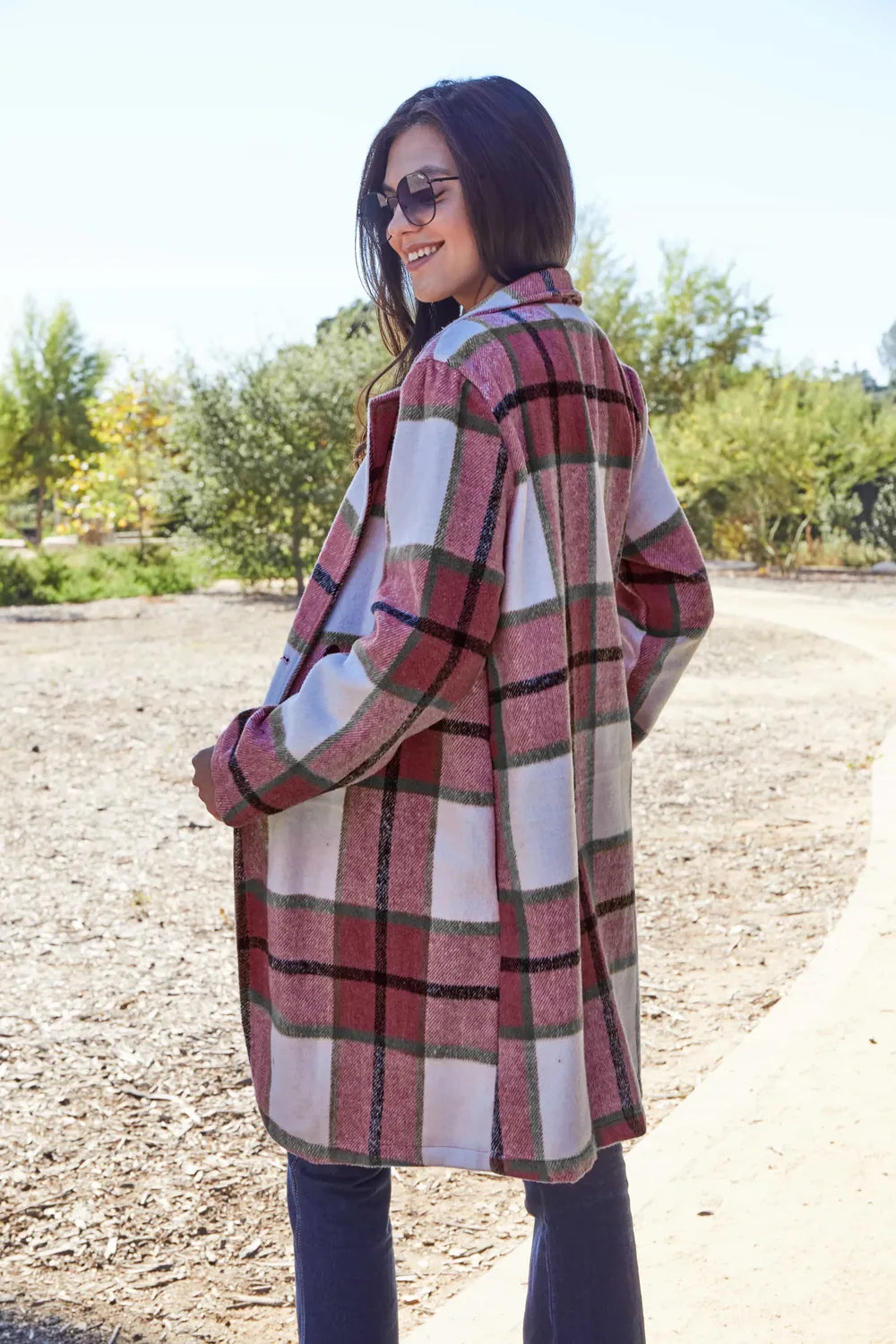 Red plaid coat side view with hand in pocket outdoors