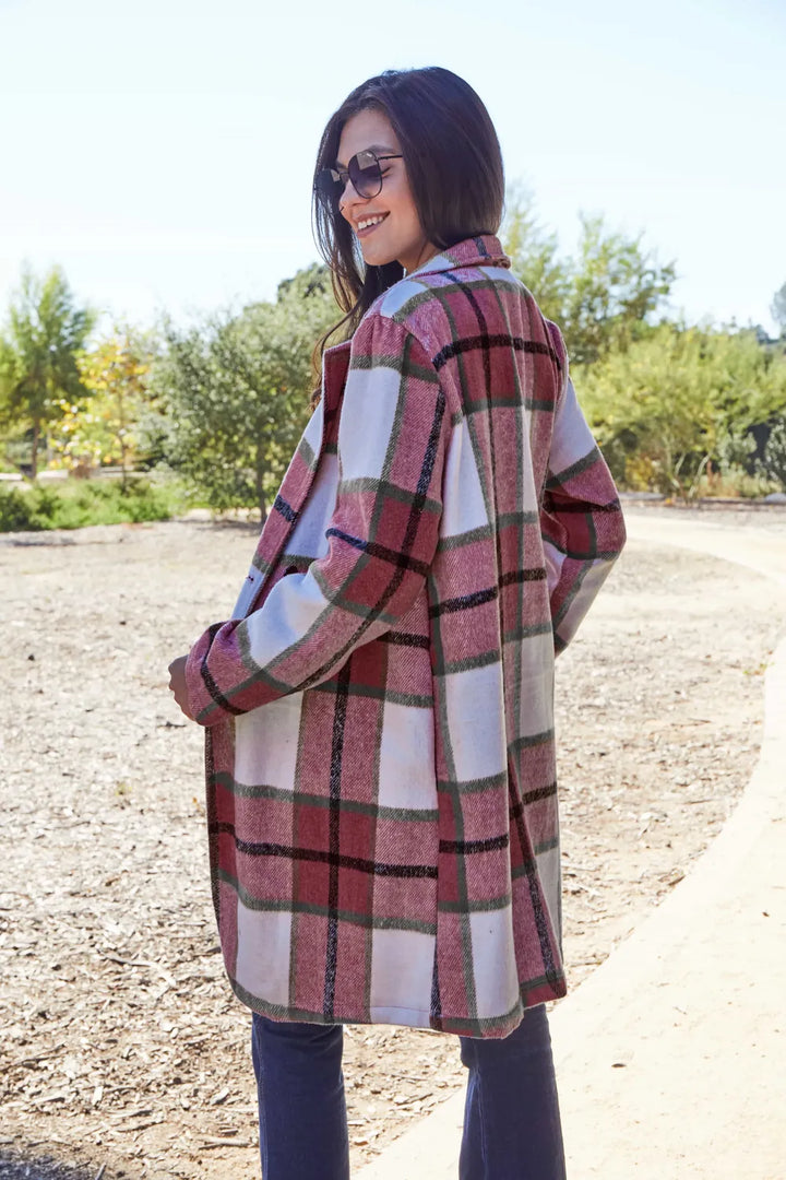 Red plaid coat side view with hand in pocket outdoors