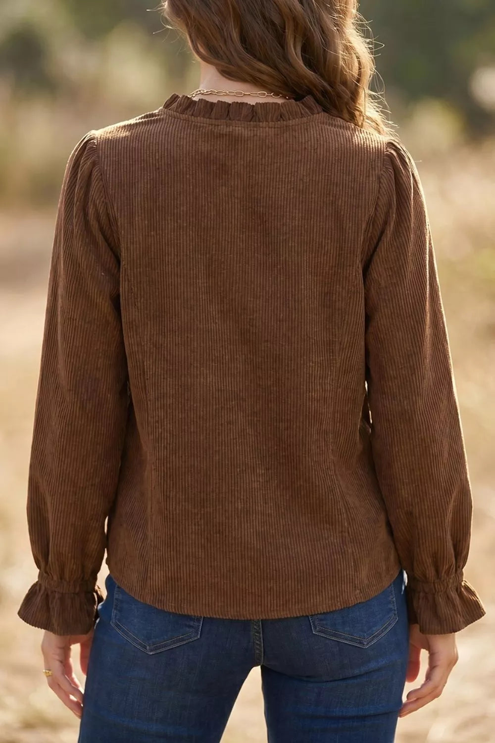 Rear view of the dark brown corduroy shirt worn with dark denim