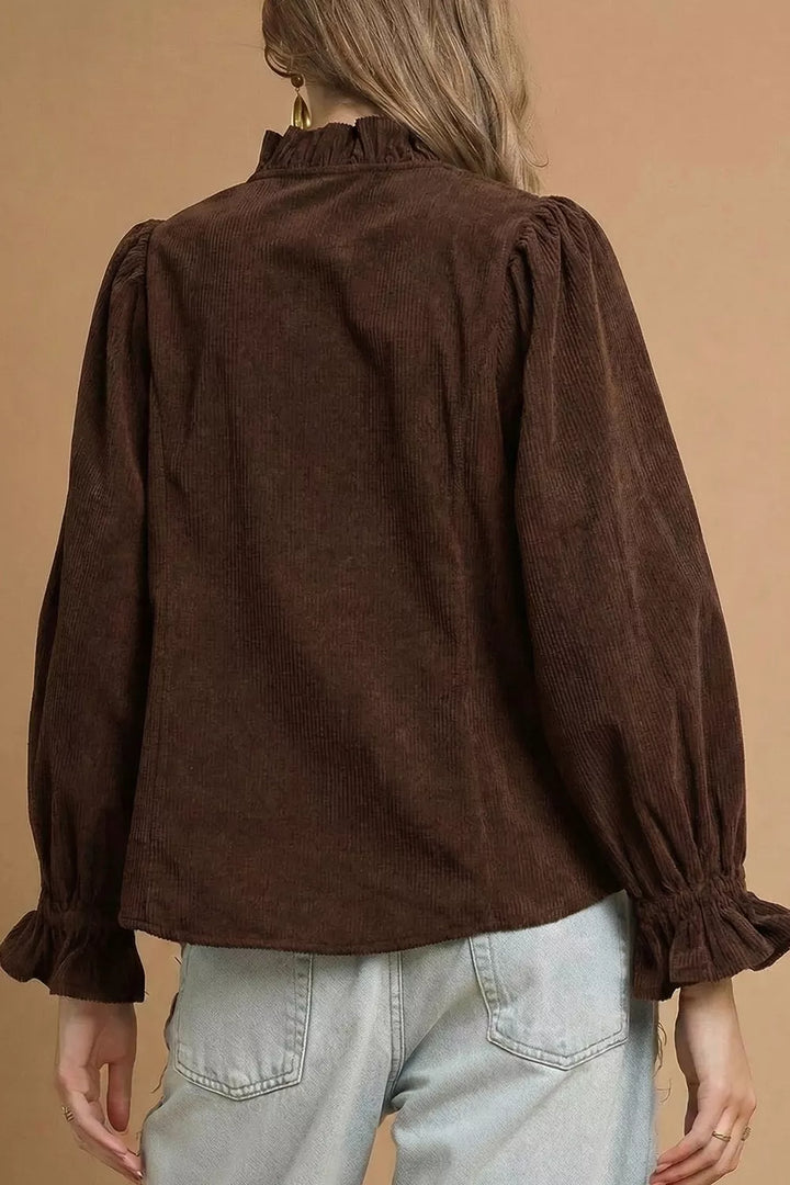 Back view of the dark brown corduroy blouse with ruffled cuffs and puffed sleeves