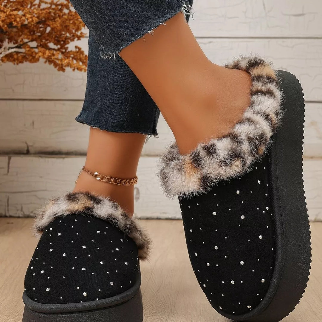 Side view of the black platform slip on slippers worn with ankle chain