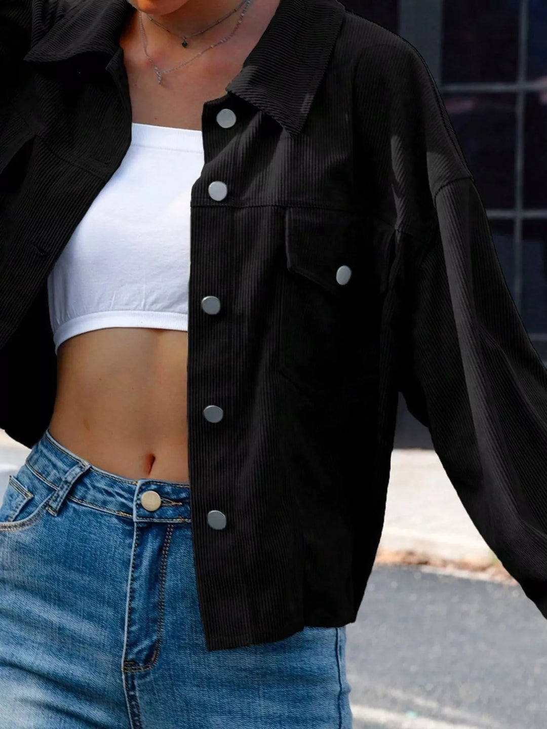 Black cropped shirt jacket, close-up of the pocket and button placket