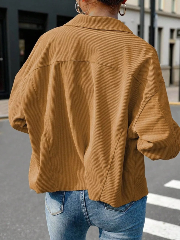 Back view of the camel cropped jacket with seam details