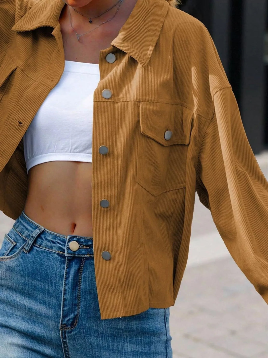Camel cropped shirt style jacket, close-up of the buttons and chest pocket