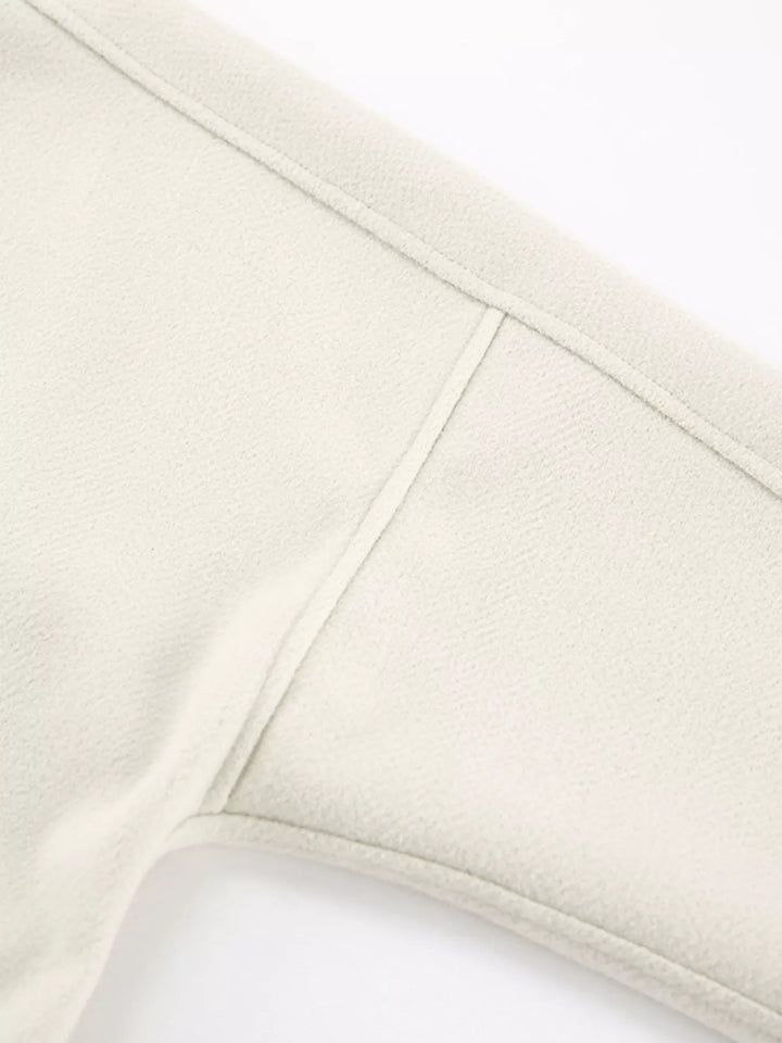 Detail of the ivory jacket dropped shoulder seam