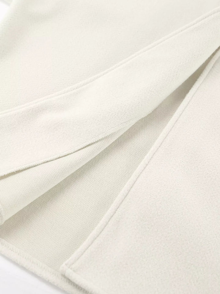 Detail of the ivory jacket side slit hem