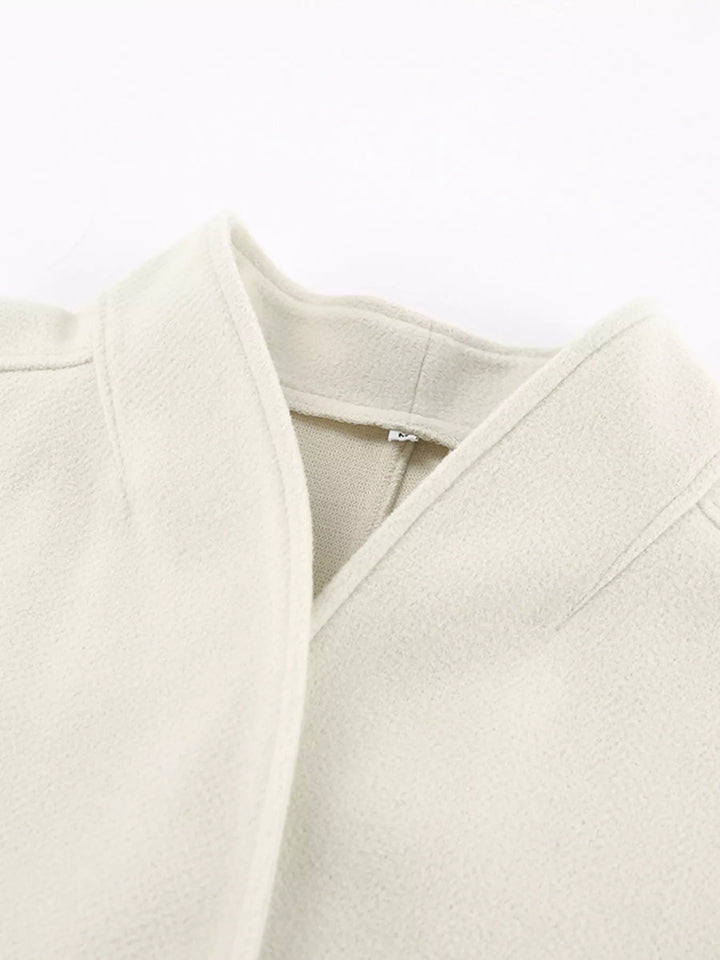 Detail of the ivory jacket open front neckline