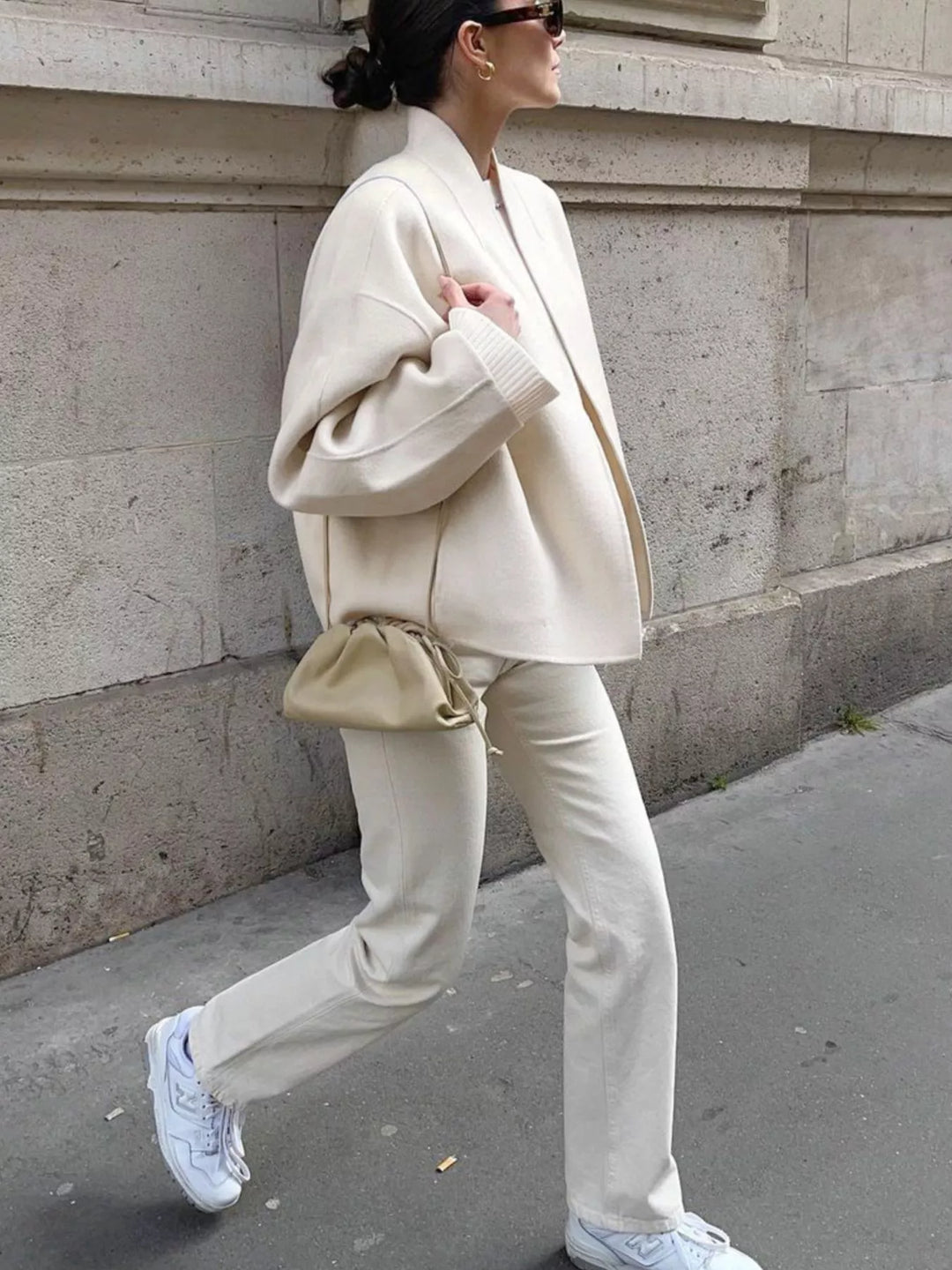Ivory cropped jacket styled with white pants and sneakers