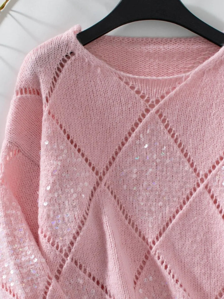 Detail of the dusty pink sweater round neckline and sequin diamond pattern