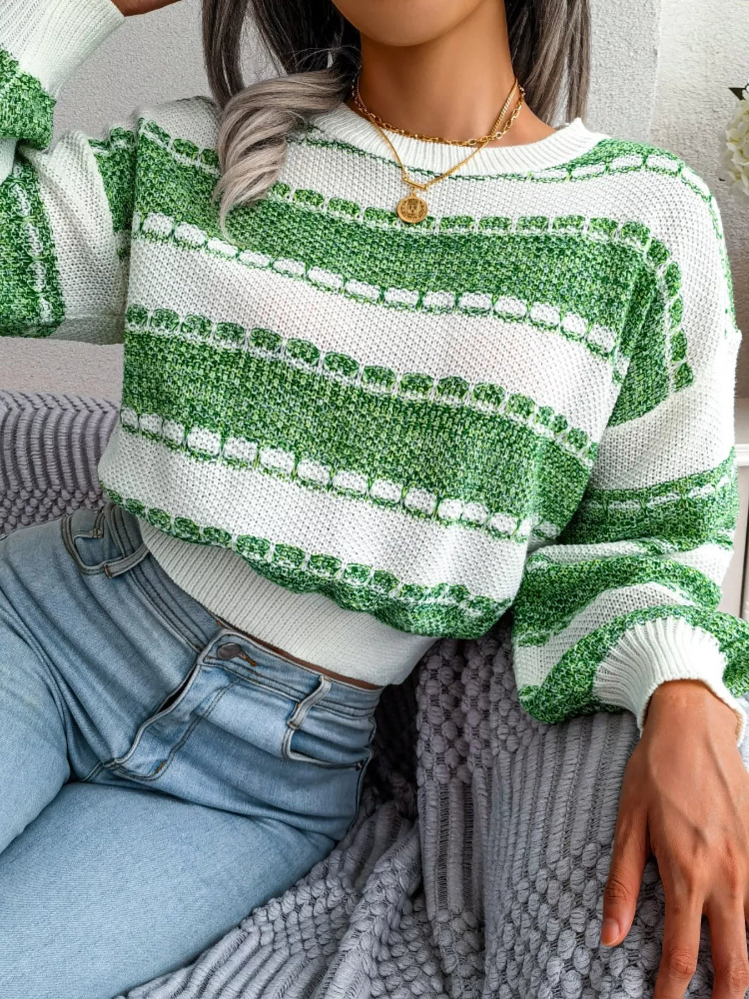 Green wide stripe cropped sweater, seated pose with jeans