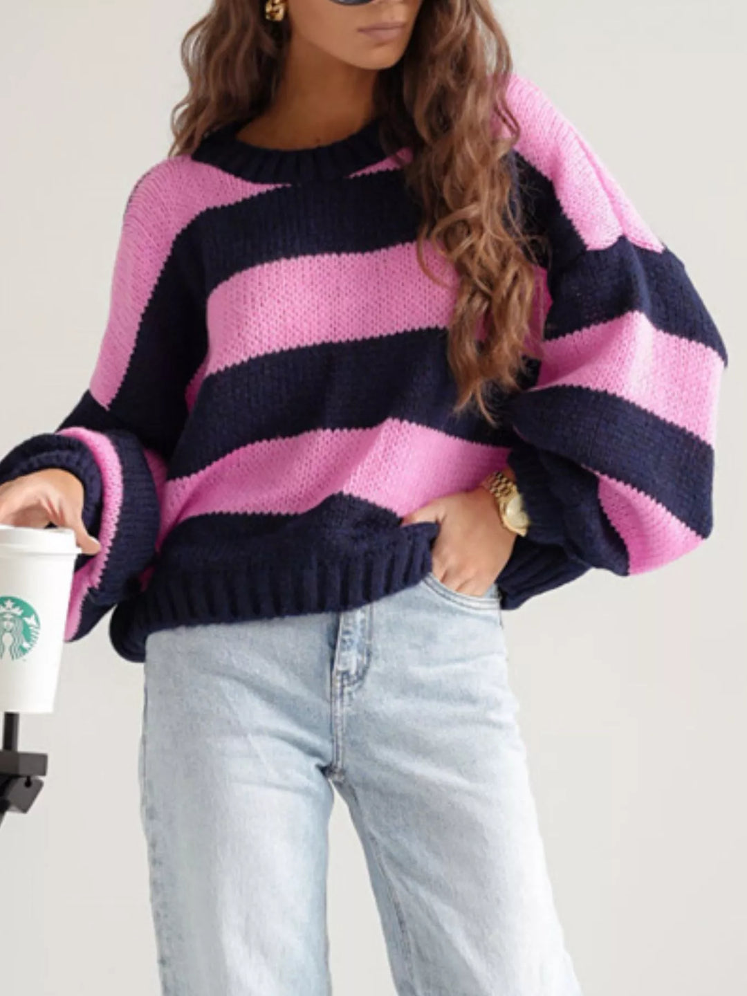 Pink and navy cropped sweater, angled view with hair over the shoulder