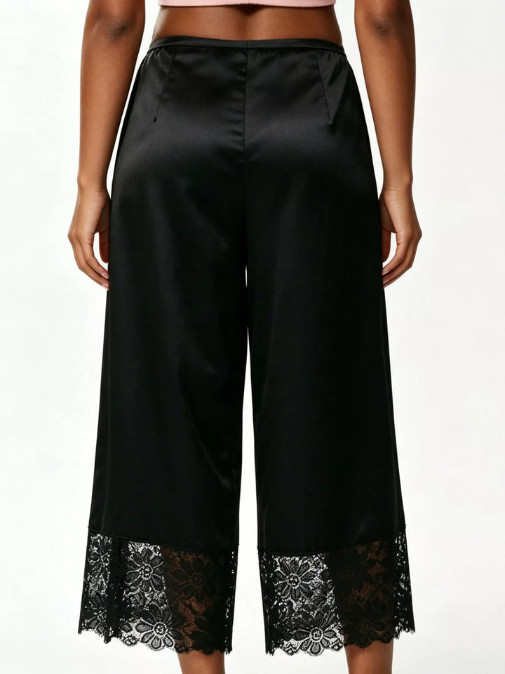 Back view of the black cropped wide leg pants with a lace trimmed hem