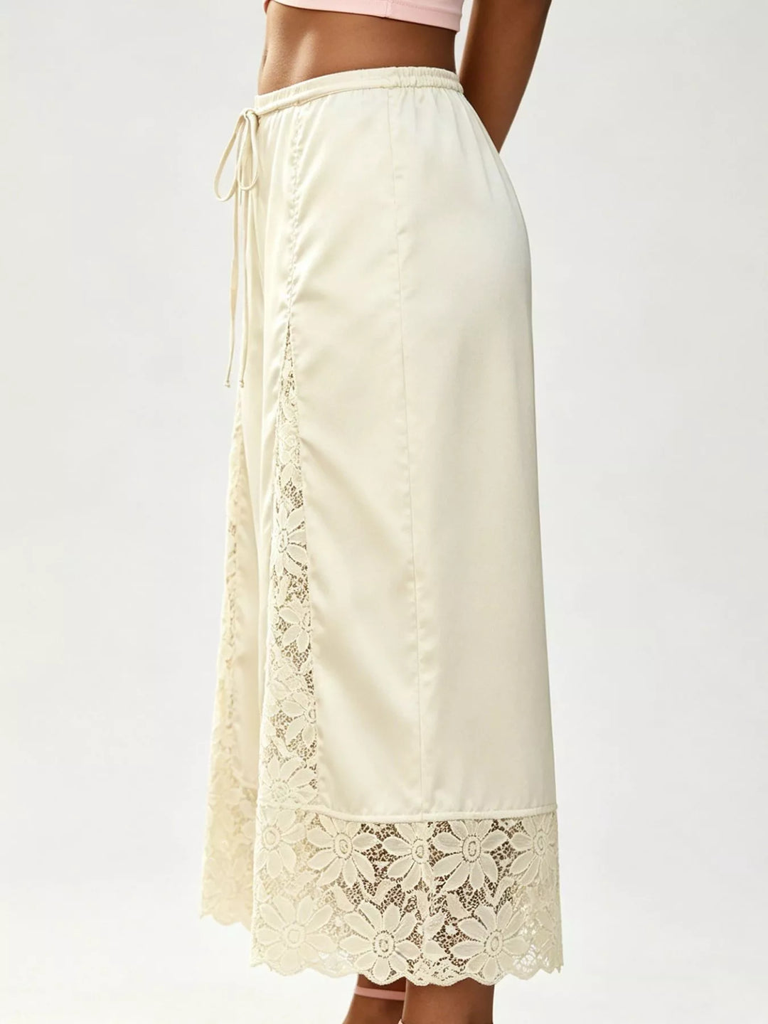 Side view of the champagne satin look pants with a lace trimmed hem