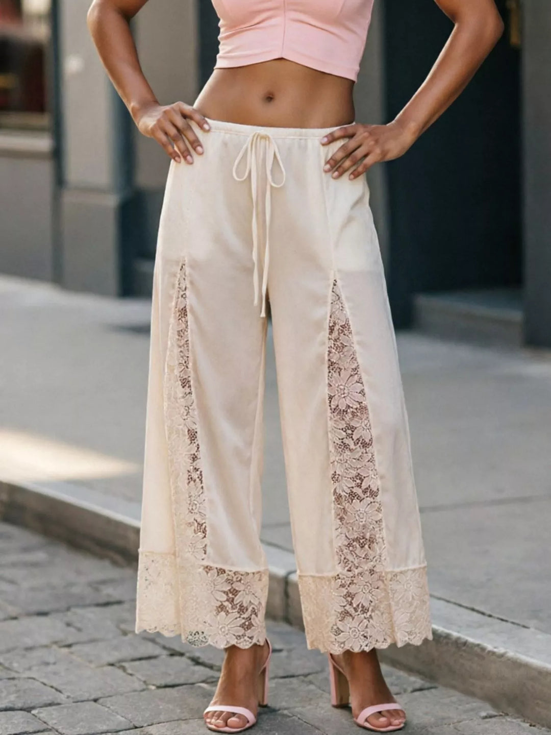 Full-length ivory cropped pants worn with a pink top and strappy heels