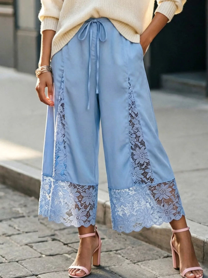 Light blue cropped pants with drawstring waist styled with a cream sweater and pink heels