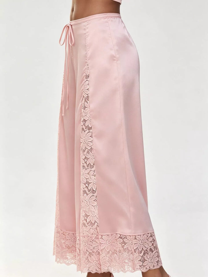 Side view of the pink cropped pants showing the gathered drawstring waist and lace