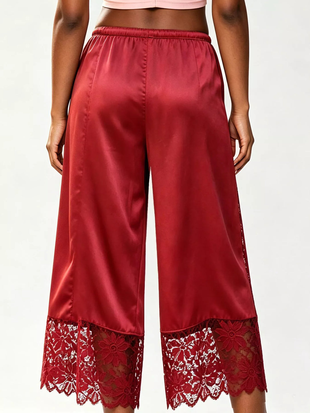 Back view of the red cropped wide leg pants with a lace trimmed hem